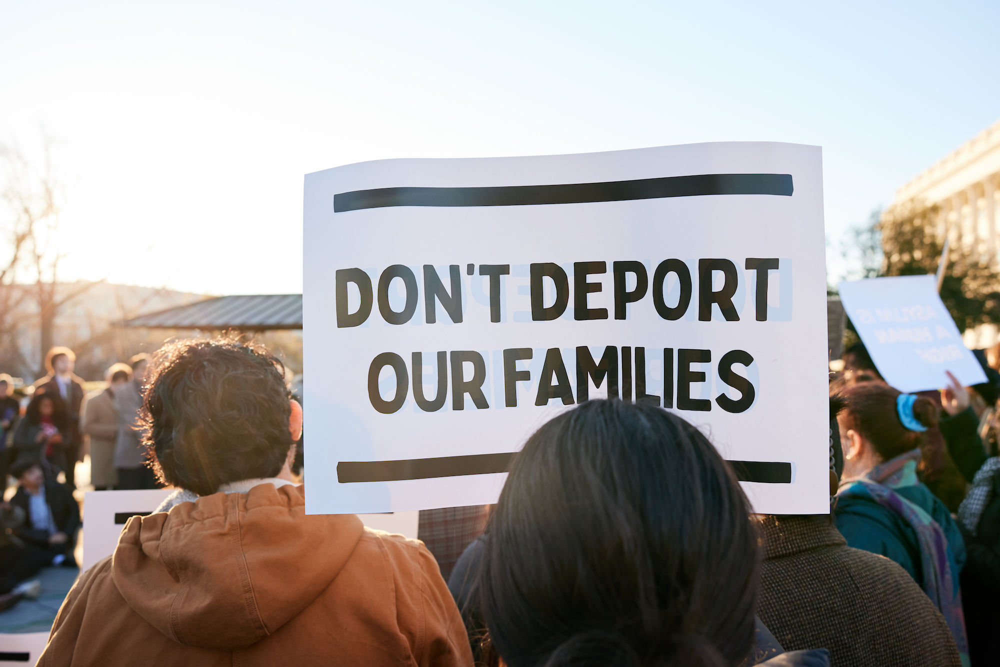 A sign that says Don't Deport Our Families.